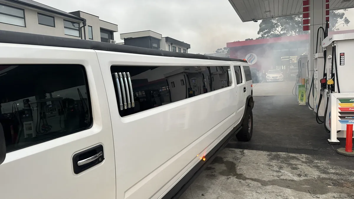 Hummer H2 stretch limo blowing smoke on start-up as leftover diesel burns off after the fuel drain