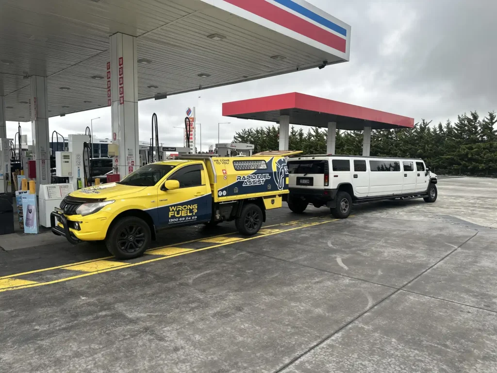 White Hummer H2 stretch limo with diesel in the petrol tank, parked behind the Rapid Fuel Assist ute at Liberty Greenvale