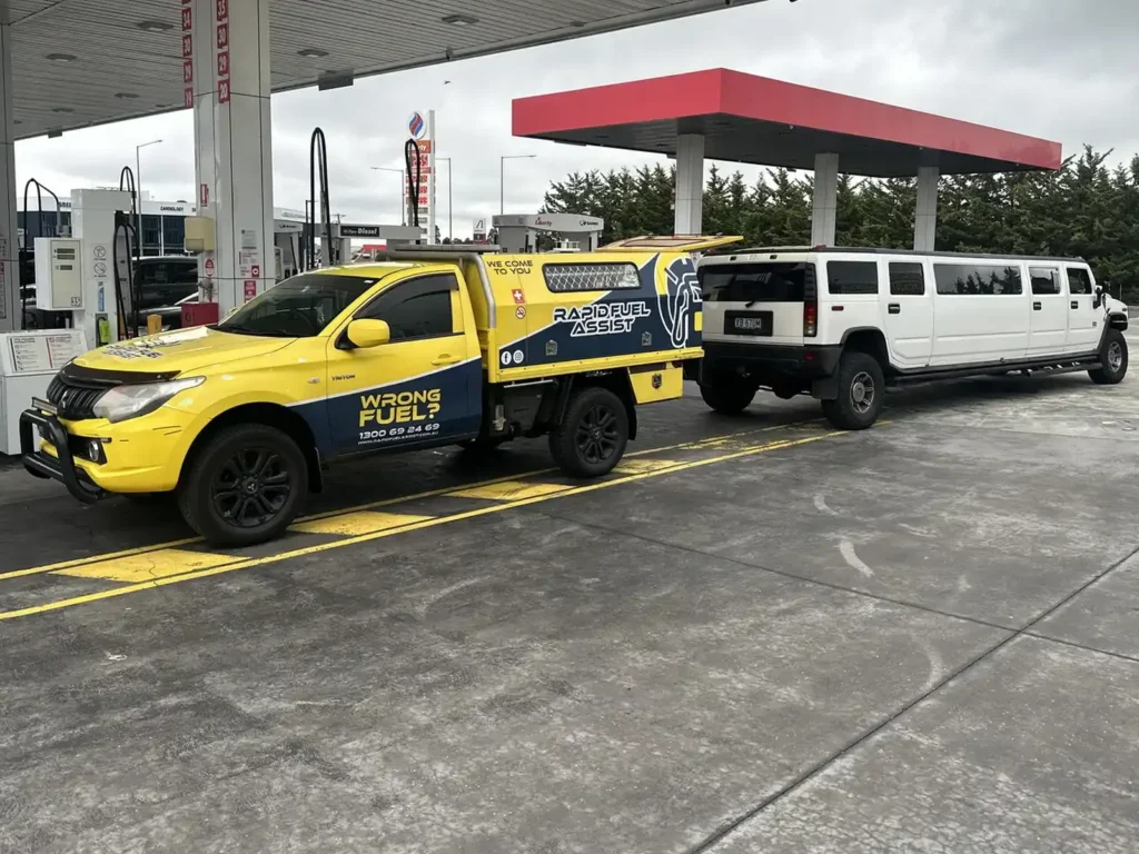 White Hummer H2 stretch limo with diesel in the petrol tank, parked behind the Rapid Fuel Assist ute at Liberty Greenvale