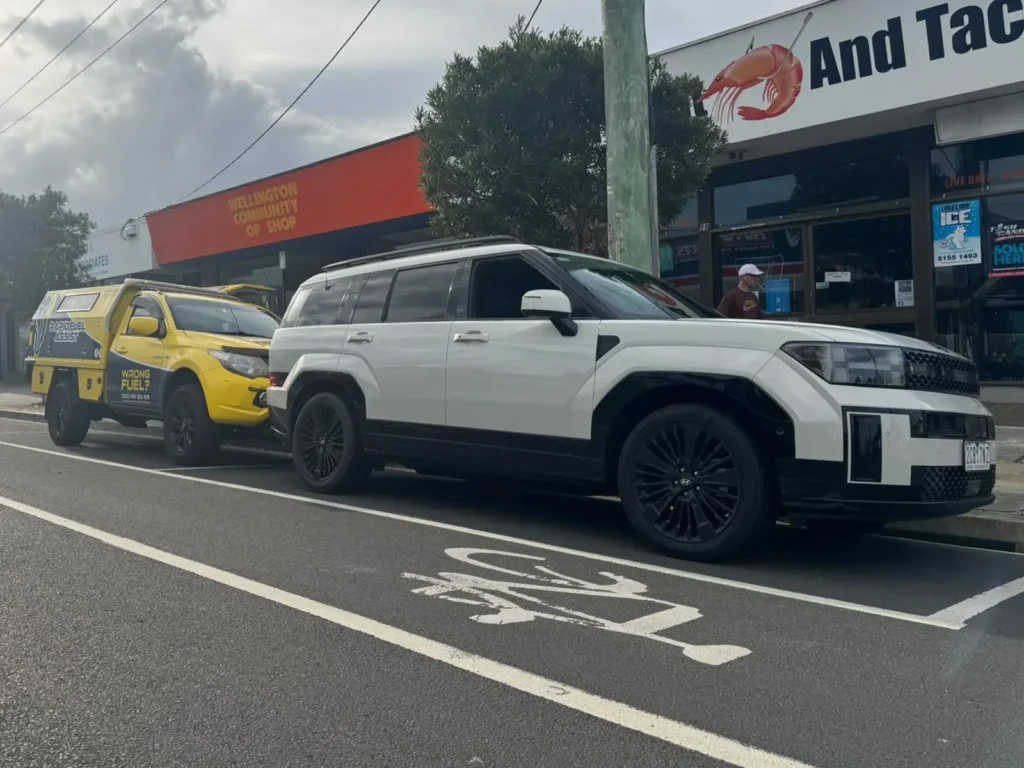 Hyundai Santa Fe Hybrid with diesel in the petrol tank, parked with the Rapid Fuel Assist ute on the main street in Sale