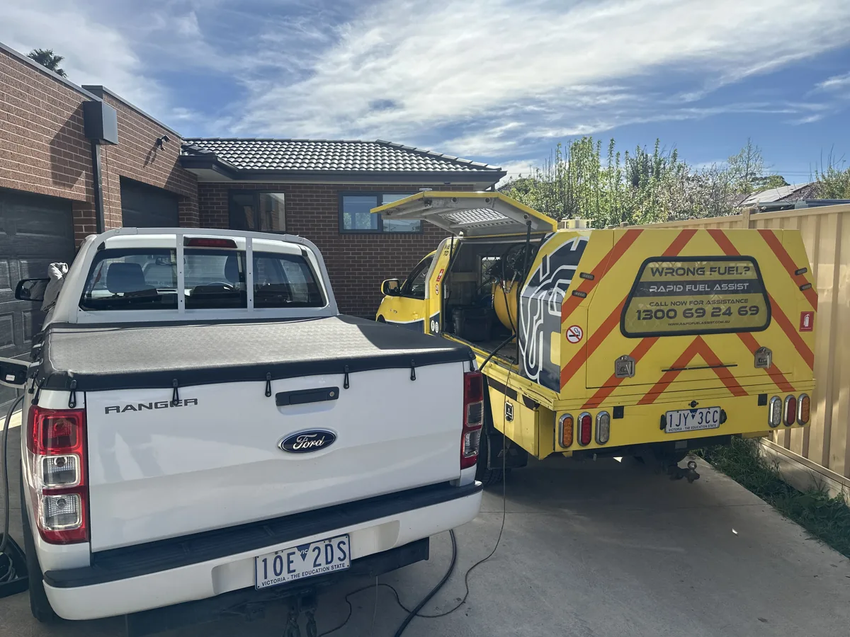 Rapid Fuel Assist ute draining petrol from a Ford Ranger's diesel tank in a home driveway in Doveton, near Dandenong