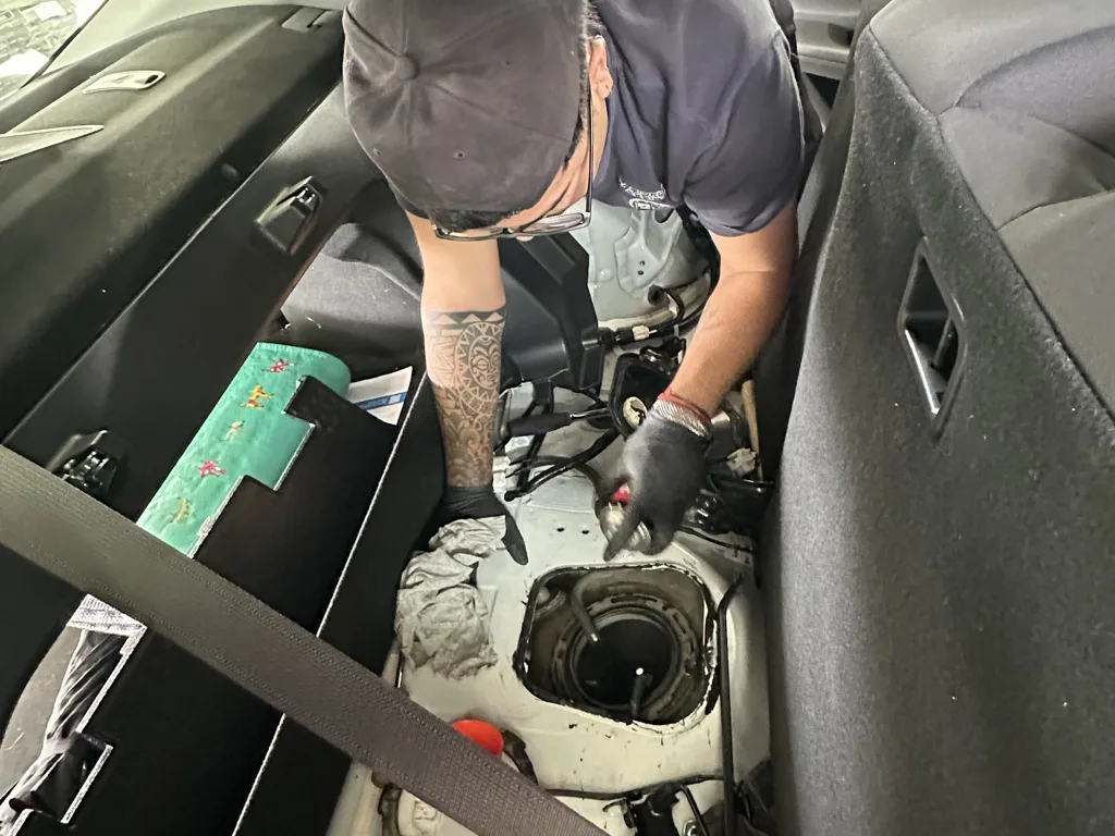 Rapid Fuel Assist technician cleaning the fuel tank of a Toyota Camry Hybrid after AdBlue was put in it at BP Wallan
